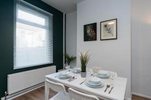 a white dining room with a white table and chairs at Chic 3BR House in Hull - sleeps 5 in Hull