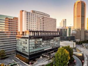 a tall building with a sign on it in a city at HostWise Stays -The Washington at Chatham - Gym - Free Garage Parking - City Views - More in Pittsburgh