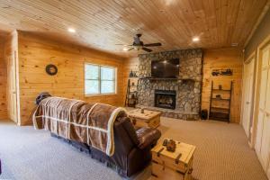 a living room with a couch and a fireplace at High Road Cabin in Banner Elk