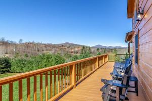 a deck with benches on the side of a house at Hilltop Haven in Boone