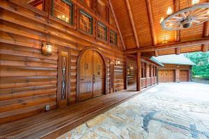 an empty porch of a wooden house with a ceiling at Lake Haven Lodge in Wilkesboro +48 photos