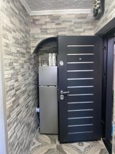 a refrigerator in a room with a brick wall at Pleasure stay in Sovata