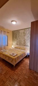 a bedroom with a large bed in a room at Apartman "Cvita" in Drage