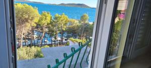 a view of the water from a window at Apartman "Cvita" in Drage