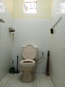 a bathroom with a toilet and a window at FonMark Haven in Webuye