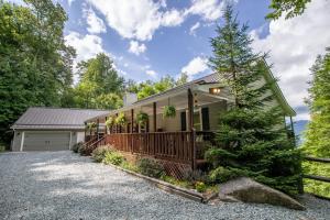 a house with a pine tree in front of it at Meadow View in Banner Elk