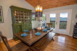 a dining room with a wooden table with blue dishes at Meadow View in Banner Elk
