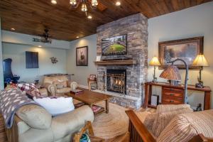 a living room with a fireplace and a couch at Meadow View in Banner Elk