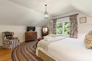 a bedroom with a bed and a chair and a window at Morning Star in Banner Elk