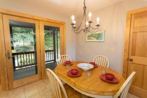 a dining room with a wooden table and chairs at Mountain Melody in Blowing Rock