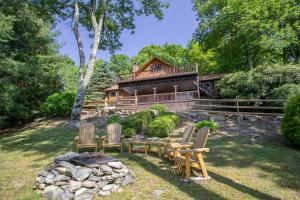 a house with a deck and chairs in the yard at Mountain Remedy in Blowing Rock