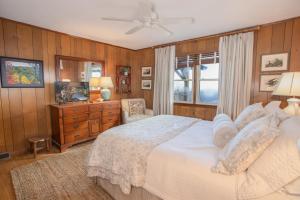 a bedroom with a bed and a dresser and a window at Out On A Limb in Blowing Rock