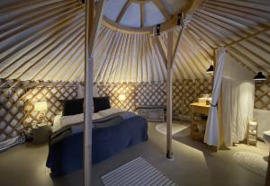 a bedroom with a canopy bed in a yurt at Náttúra Yurtel in Haukadalur