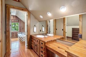 a bathroom with a sink and a large mirror at Renaissance Lodge in Blowing Rock +42 photos
