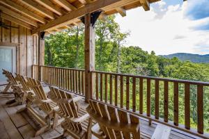 a porch with chairs and a view of the mountains at Renaissance Lodge in Blowing Rock