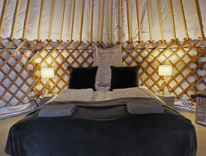 a bedroom with a large bed in a yurt at Náttúra Yurtel in Haukadalur