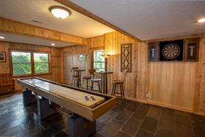 a pool table in a room with wooden walls at Serendipity in Blowing Rock