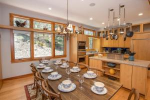 a dining room with a table and chairs and a kitchen at Snow Dog Lodge in Beech Mountain