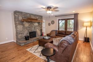 a living room with a couch and a stone fireplace at Starlight Ridge in Seven Devils