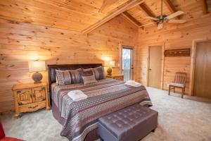 une chambre avec un lit dans une cabane en rondins dans l'établissement Sugar Bear, à Sugar Mountain