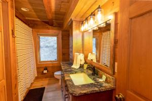 a bathroom with a sink and a mirror at Stoney Brook Cabin in Boone +22 photos