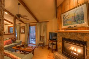 a living room with a fireplace and a couch at Sugar Maple at Fiddlestix in Boone