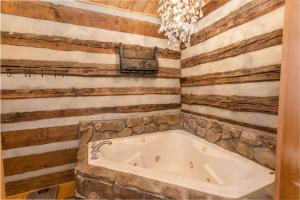 a bath tub in a room with a stone wall at Speckles in Todd +35 photos