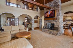 a living room with a couch and a stone fireplace at Sunset Beech in Beech Mountain