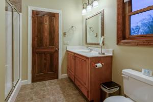 a bathroom with a sink and a mirror and a toilet at Sunset Lodge in Blowing Rock +34 photos