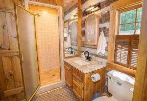 a bathroom with a shower and a sink and a toilet at The Berry Patch in Blowing Rock