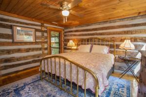 um quarto com uma cama num chalé de madeira em The Berry Patch em Blowing Rock