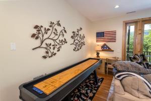 a pool table in a living room with an american flag at The Ponderosa in Boone +29 photos