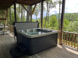 a hot tub on the deck of a house at The Ponderosa in Boone