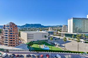 a city with cars parked in a parking lot at Villas Guzman - Apartamento Apolo XI in Calpe