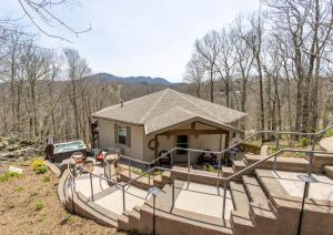 a small house with a porch and a driveway at Top Of The Hill in Seven Devils