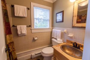 a bathroom with a sink and a toilet and a window at Top Of The Rock in Blowing Rock +12 photos