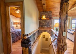a staircase in a house with a bear statue in theoyer at Top Of The Rock in Blowing Rock