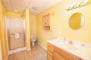 a bathroom with a shower and a sink and a toilet at Waters Edge Retreat in Wagoner +35 photos
