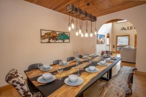 a dining room with a long table and chairs at Villa Costalotta in Sugar Mountain