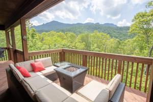a patio with a couch and a table on a deck at Villa Costalotta in Sugar Mountain