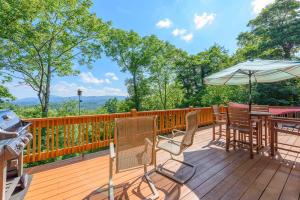 a deck with a table and chairs and an umbrella at Valle Crucis Overlook in Banner Elk