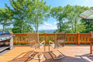 two chairs sitting on a deck with a grill at Valle Crucis Overlook in Banner Elk +34 photos