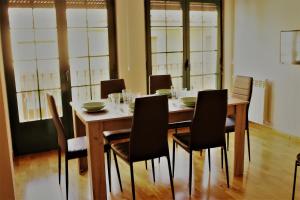 a dining room table with chairs and a table and chairsktop at Vergarillas 2 in Ávila +4 photos