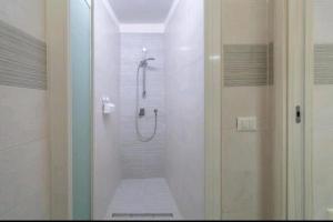 a bathroom with a shower with a glass door at LA CASA DEI CANDELAI in Siracusa +7 photos