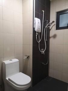 a bathroom with a toilet and a shower at Free Netflix&WiFi Putrizarreth Skyhouse Kt Town in Kuala Terengganu