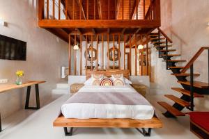 a bedroom with a bed and a spiral staircase at Blerina's Agritourism Concept in Laknas