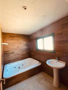 a bathroom with a tub and a sink at Rancho La Mesa 