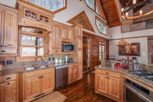 a kitchen with wooden cabinets and a ceiling with skylights at Blackberry Ridge in Blowing Rock