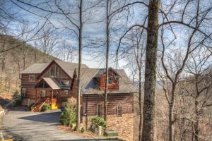 a large wooden house in the middle of a forest at Blackberry Ridge in Blowing Rock