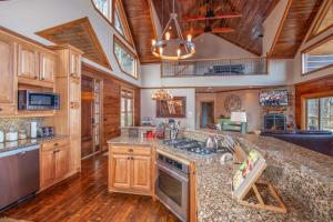 a kitchen with wooden cabinets and a large counter top at Blackberry Ridge in Blowing Rock